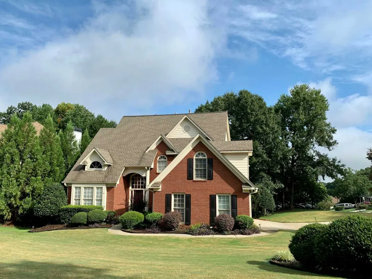 Brick two-story home with a front lawn
