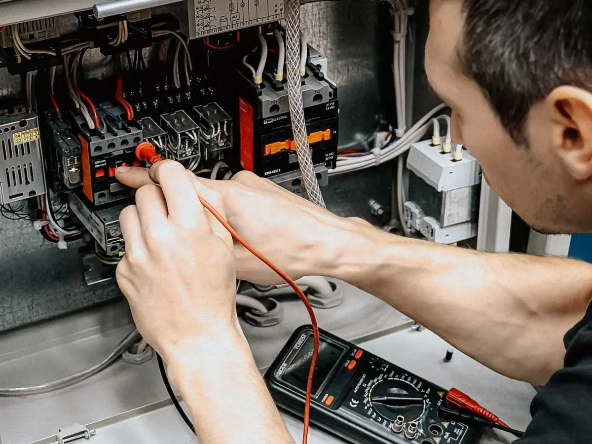 Technician testing heater wiring with a multimeter