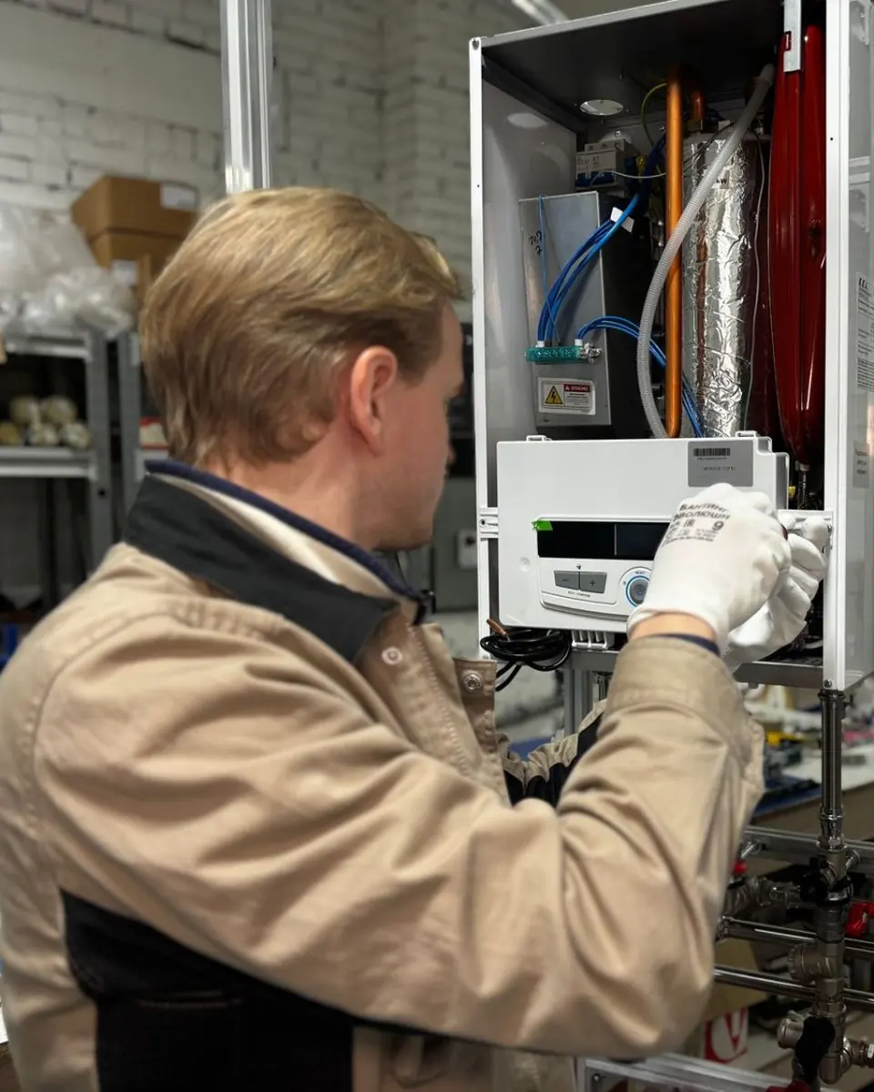 Technician servicing a wall-mounted water heater