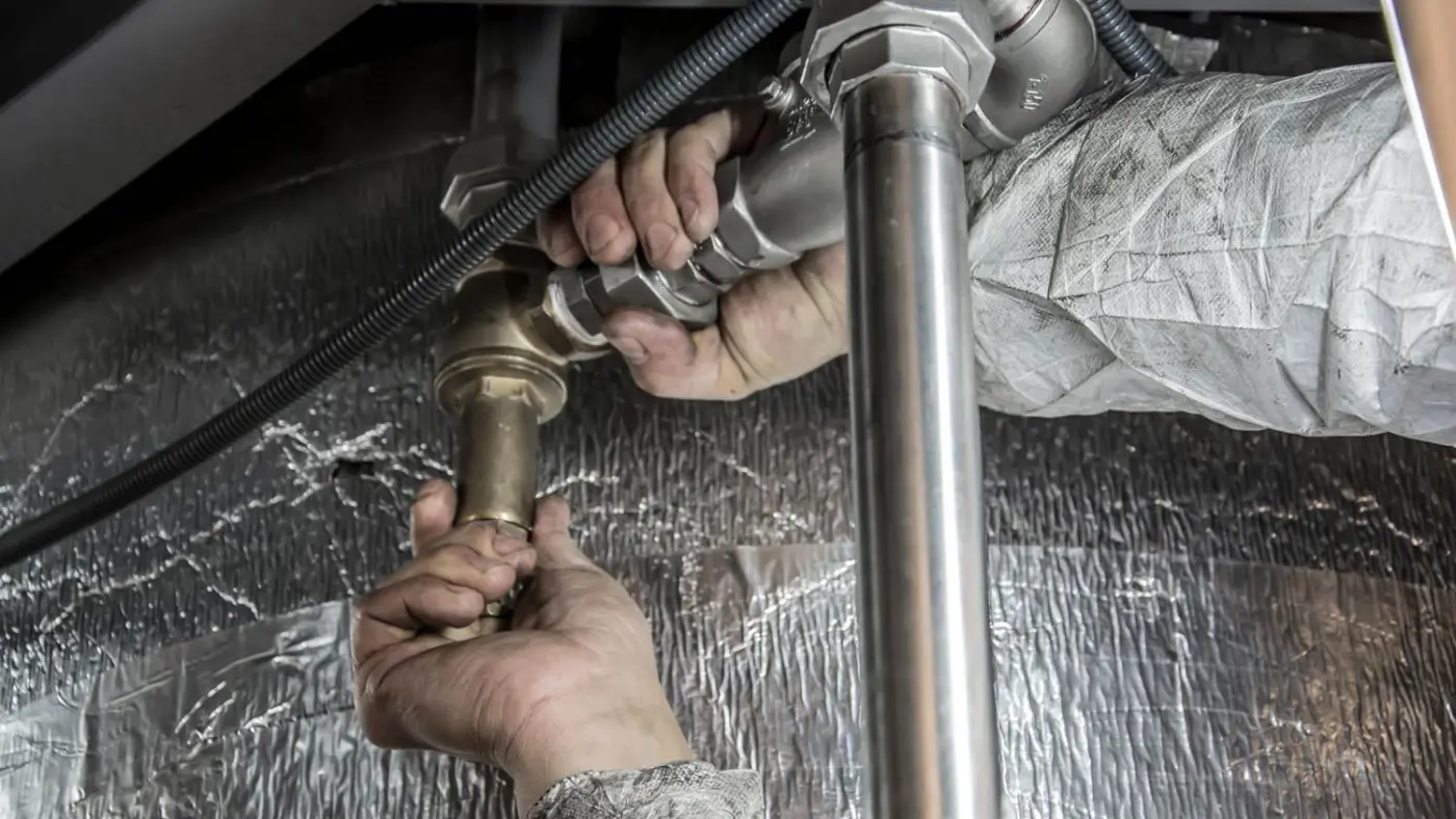 Plumber connecting new supply piping during a water heater installation